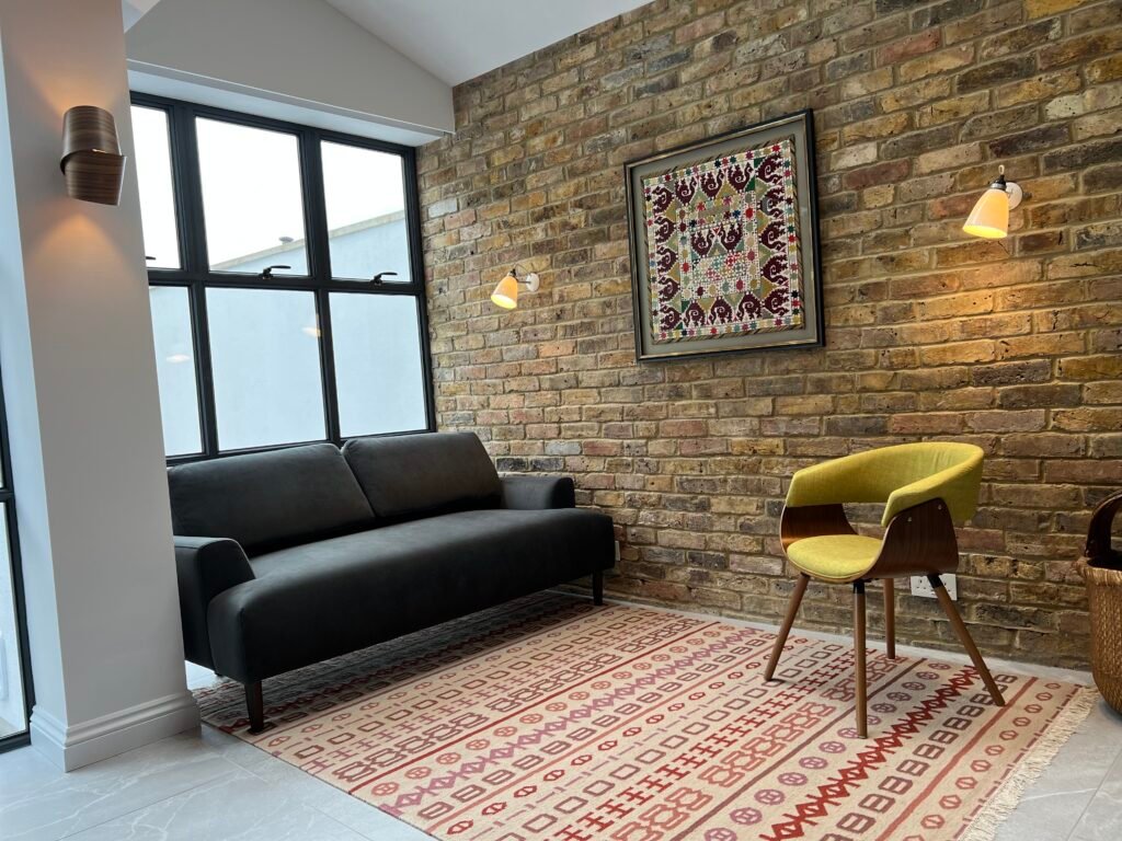 Extension built with reclaimed Victorian brickwork and slim black steel windows, designed and built by Torwood Interiors in Richmond