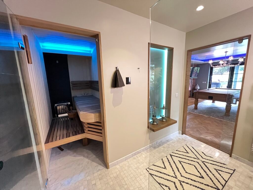 Luxury home sauna with LED lighting and games room in Purley by Torwood