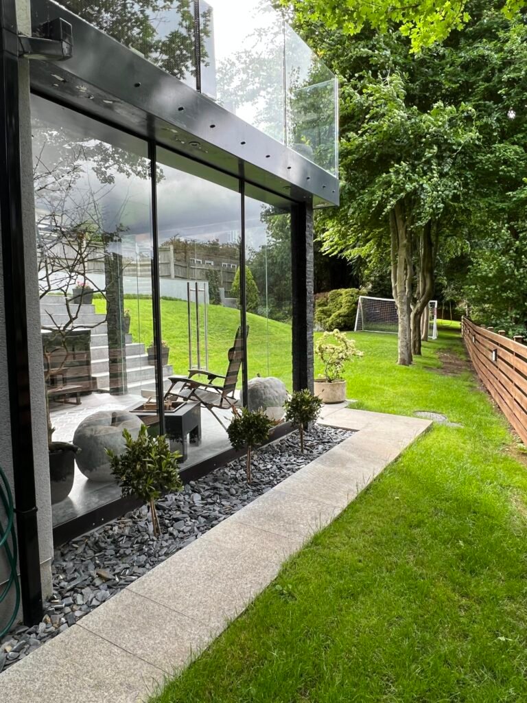 Exterior glass extension in Purley with landscaped garden by Torwood Interiors.