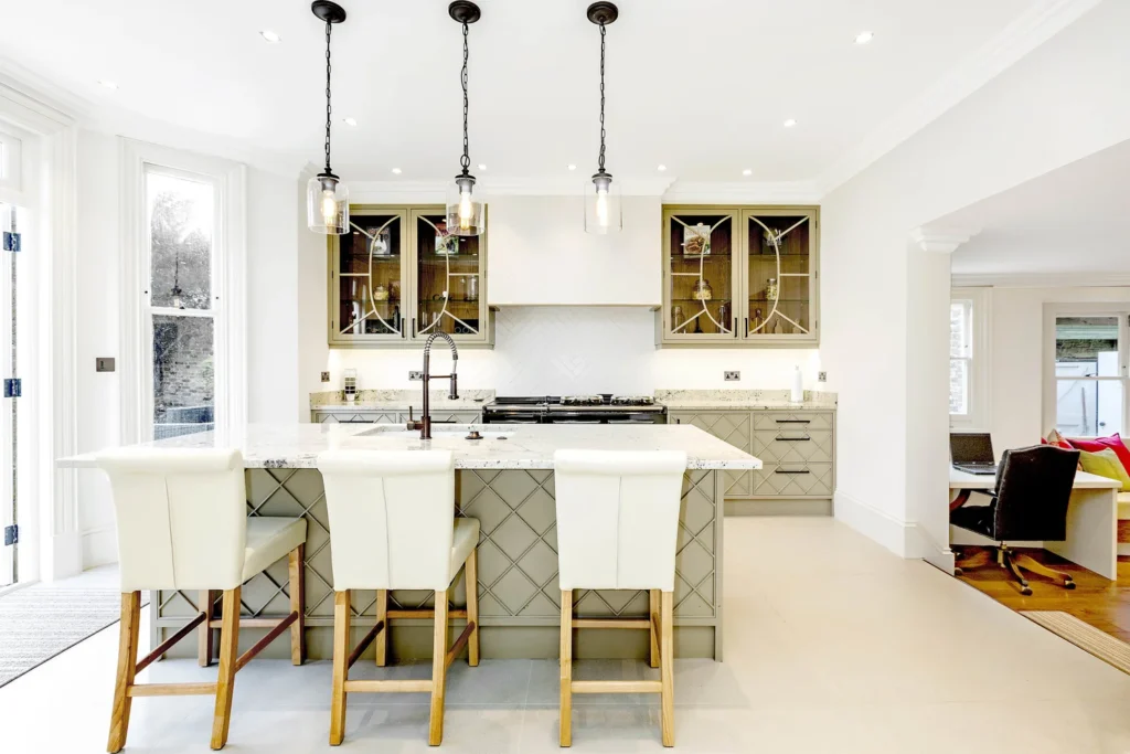 Classic shaker kitchen with marble island and glass-fronted cabinets.