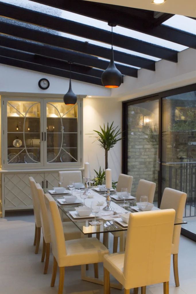 Contemporary dining space with glazed roof and custom-built cabinet