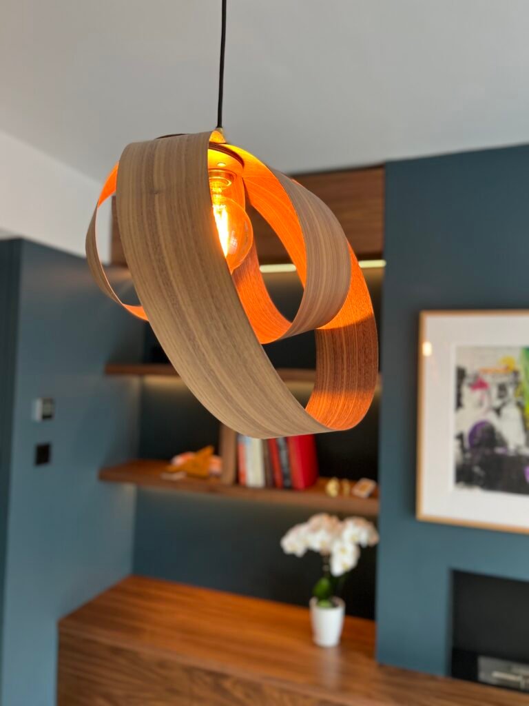 Contemporary walnut pendant light feature above bespoke joinery unit, designed and installed by Torwood Interiors in Richmond
