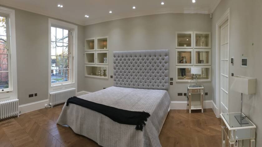 Luxury bedroom renovation with bespoke mirrored wall units in Richmond