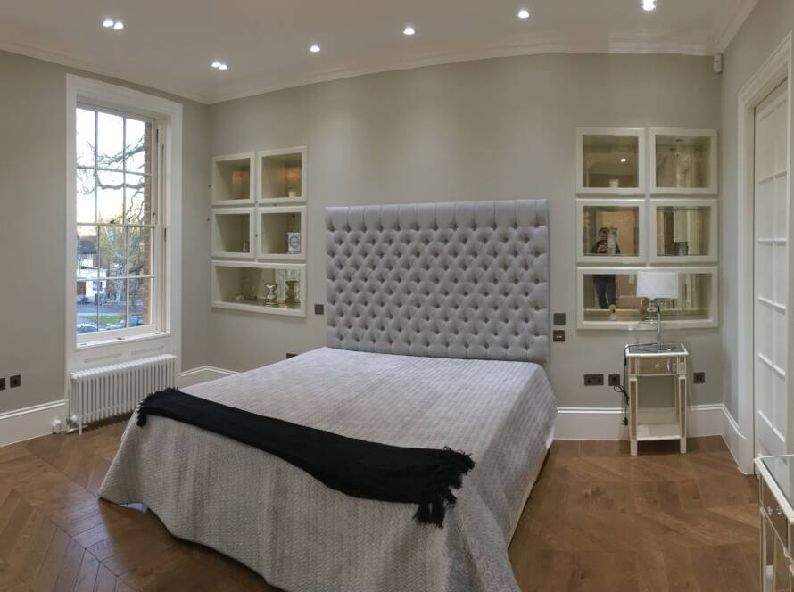 Luxury bedroom renovation with bespoke mirrored wall units in Richmond